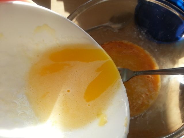 Adding melted butter to egg